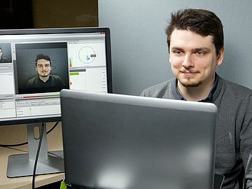 Man with a face recognition tool