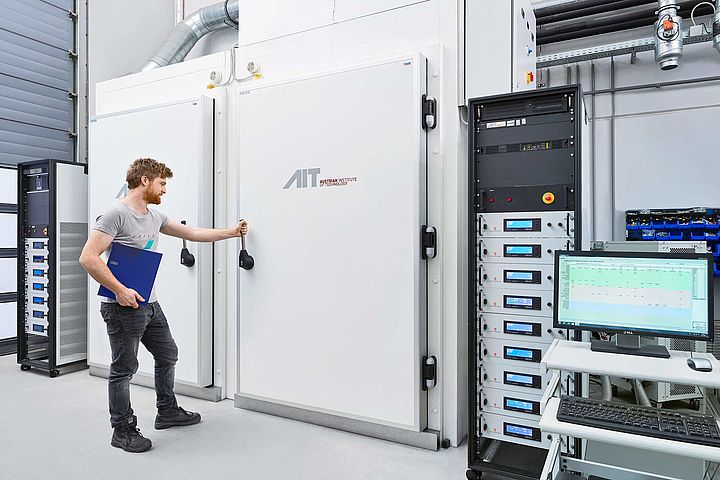 scientist opens the door to a battery testing laboratory