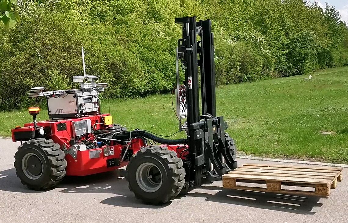 Autonomous forklift truck carrying a pallet on the AIT outdoor test site, the Large-Scale Robotics Lab