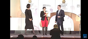 Angela Sessitsch accepts the certificate on stage