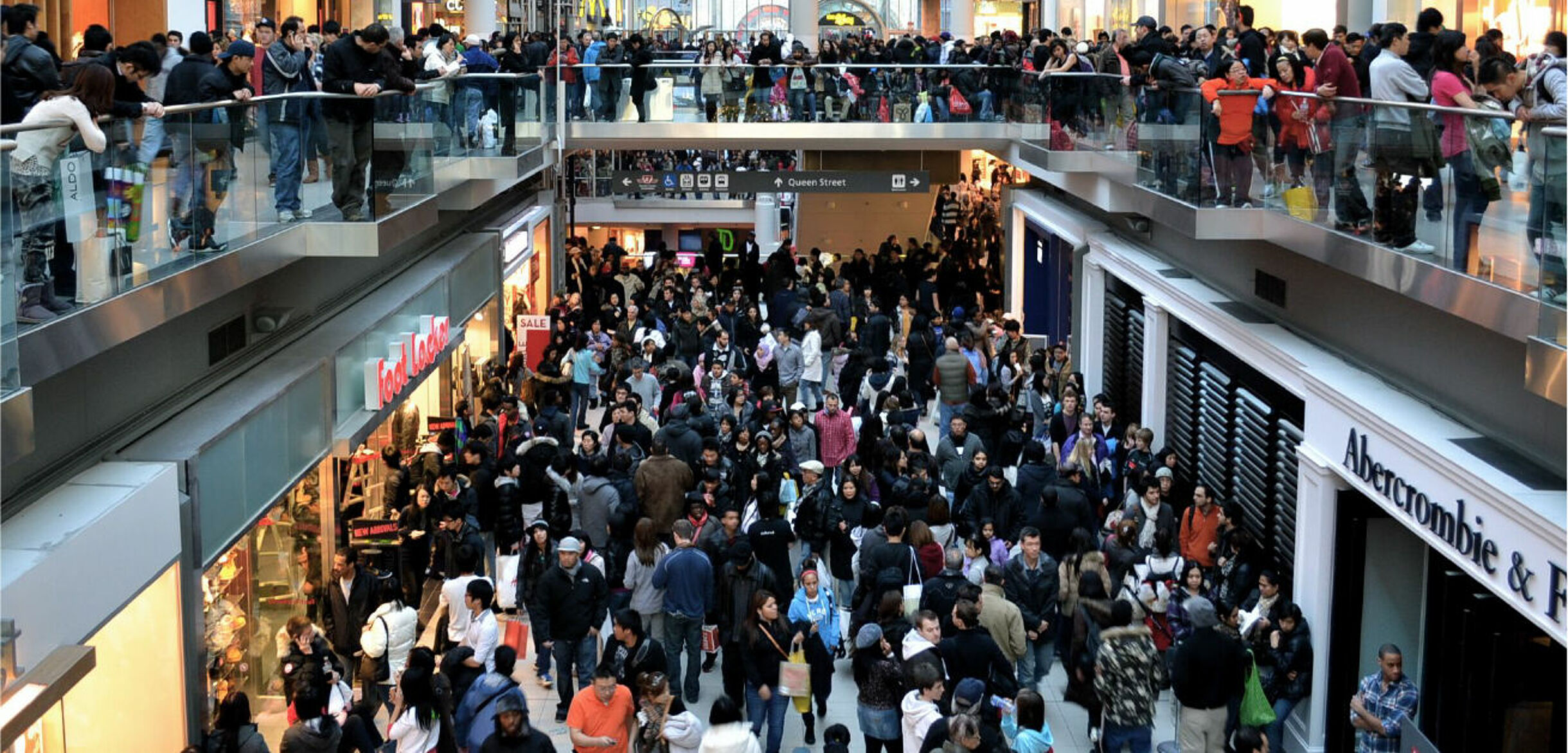 Shopping mall with crowds symbol photo