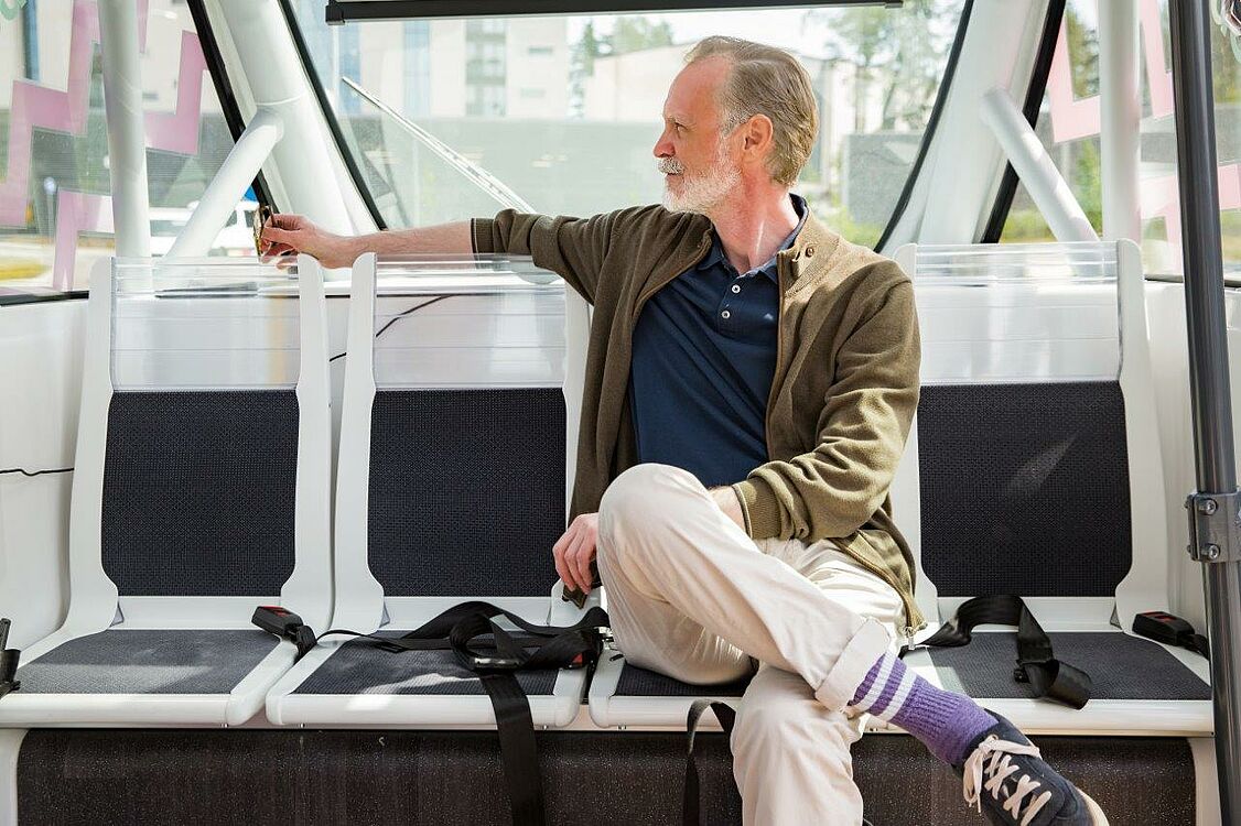 elderly gentleman sitting in a self-propelled bus