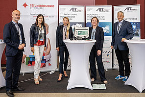 Anton Dunzendorfer, Bernadette Matiz, Juliane Bogner-Strauß, Angelika Rzepka, Peter Kastner in front of roll-ups of Gesundheitsfords Steiermark and AIT