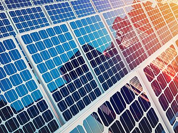 Solar panels on buildings reflect the city.