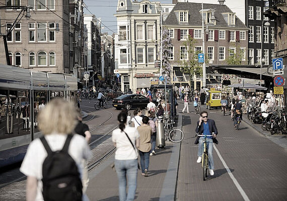 Passengers and trams on a road