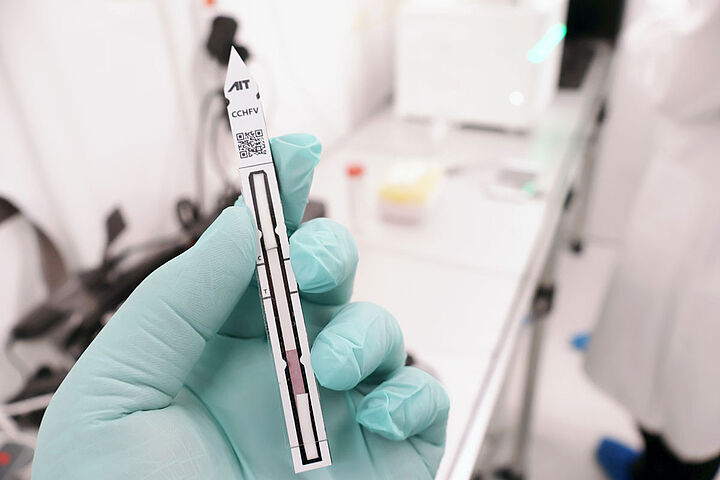 Schnelltest in Hand mit Laborhintergrund