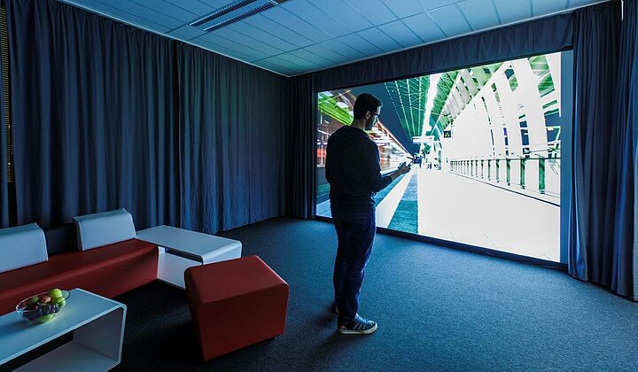 Man stands in front of big screen in TX Lab.