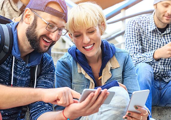 Three people with smartphones