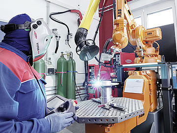 scientist using a machine in the additive manufacturing laboratory