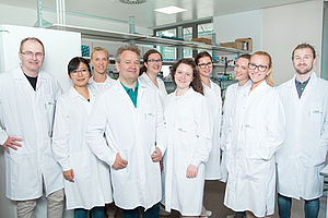 the team of Principal Scientist Winfried Neuhaus, 10 people all dressed in white AIT lab-coats