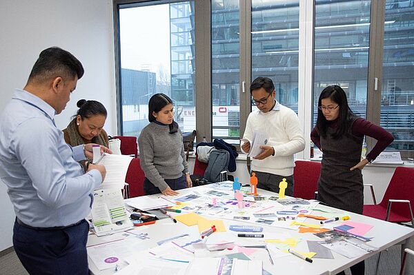 picture of five training participants working on a table