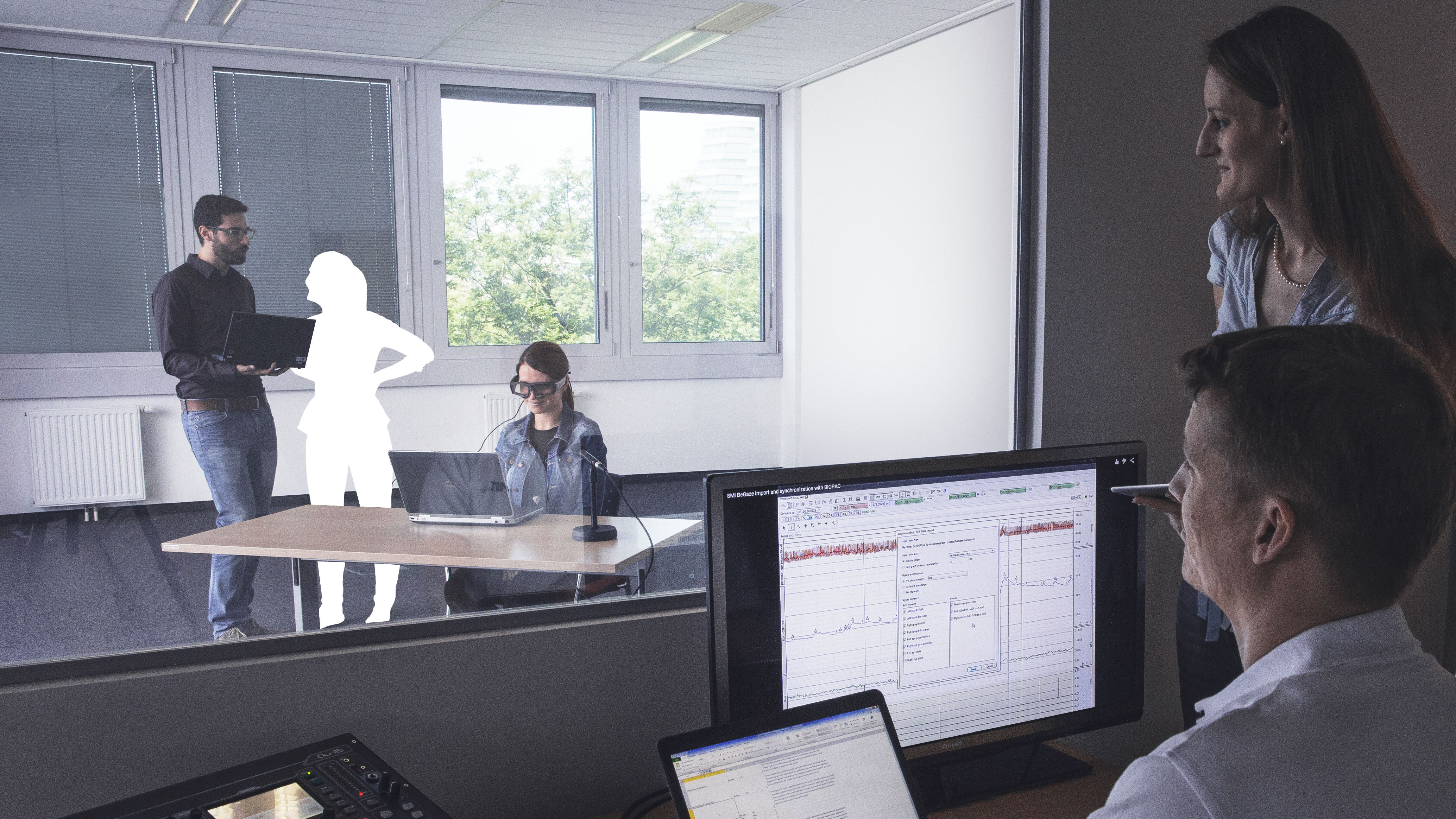 AIT Employees analyse data with cut out person