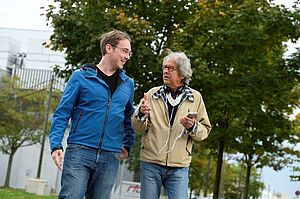 two men outside using the 3D audio navigation