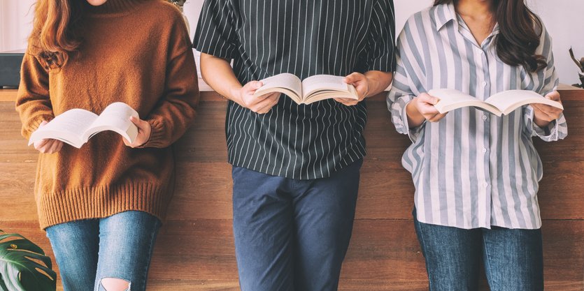 three people reading a book each