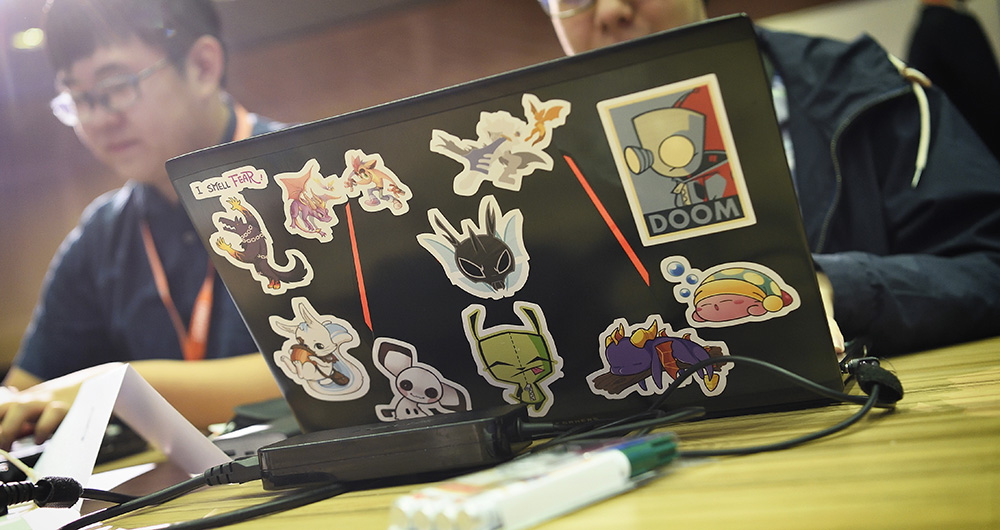 laptop with stickers on it