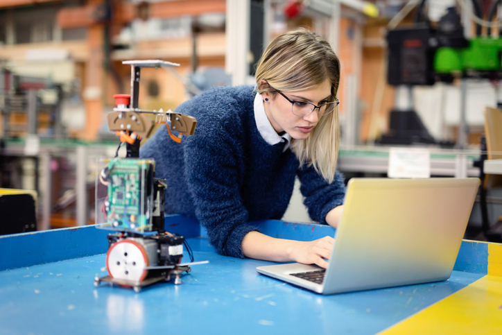 Young woman engineer working on robotics