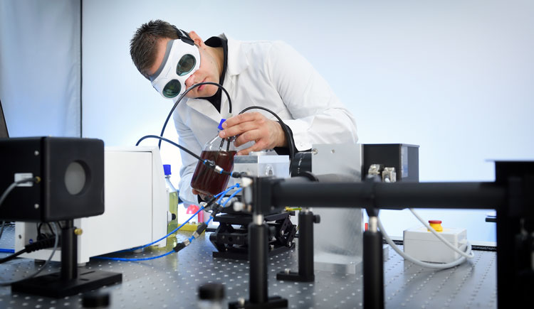 Scientist works with laser