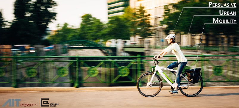 Cyclist with helmet driving across a bridge.