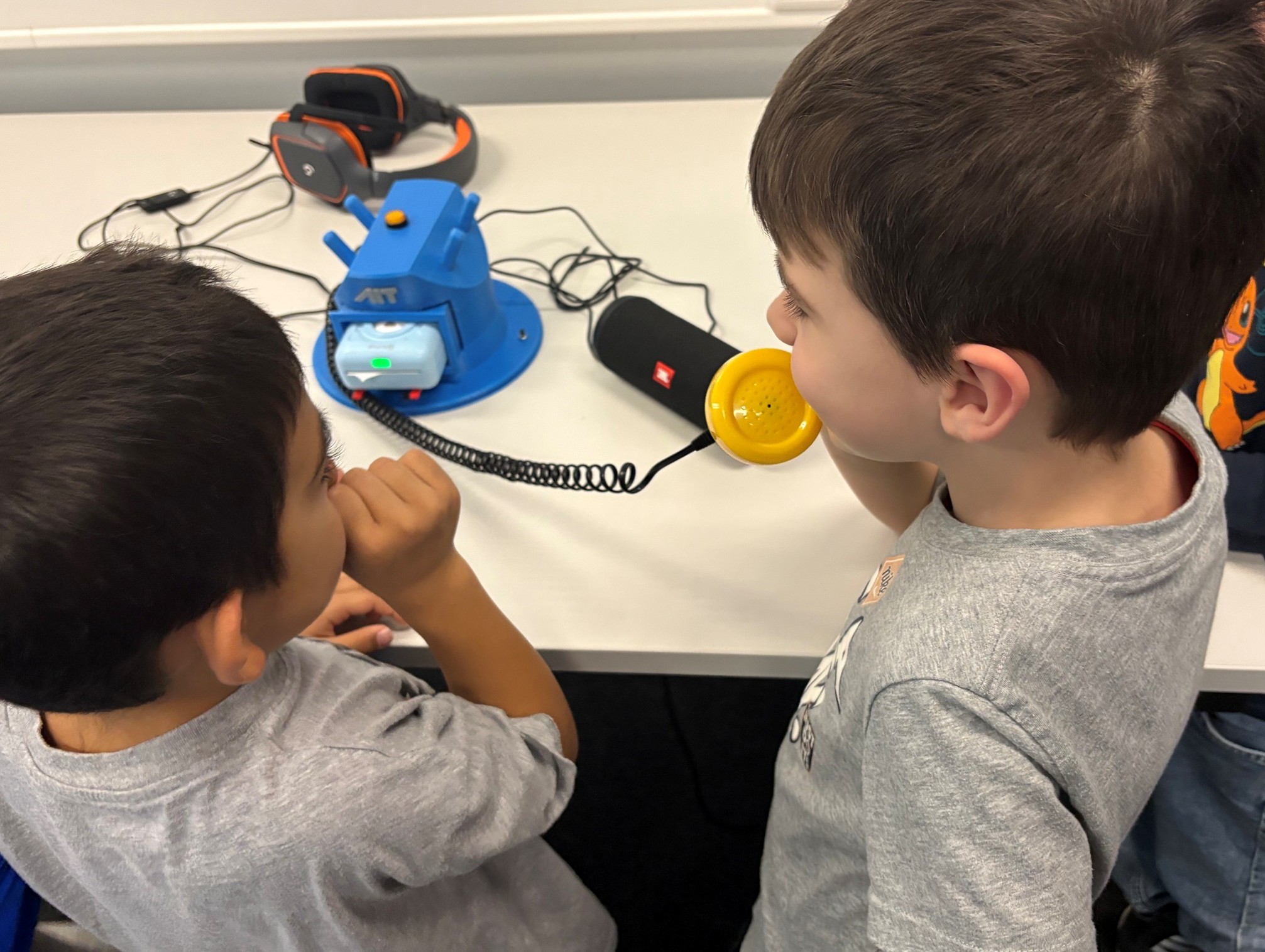 two boys with the Wisper Telephone